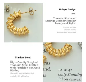 Macro view of C-shaped threaded earrings in 18K gold-plated surgical titanium steel