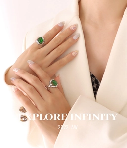 Detail of emerald crystal rings on model fingers featuring gold plated titanium steel