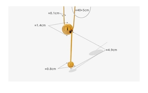Detail view of gold Y-pendant necklace with polished metal balls and long vertical bar
