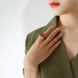 Retro gold plated stainless steel open ring with red stone and tiger eye on model's hand