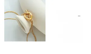 Close-up of gold-plated double-layer necklace with unique OT toggle clasp design