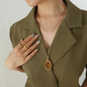 Double-layered gold titanium steel tiger eye pendant necklace and ring set on model