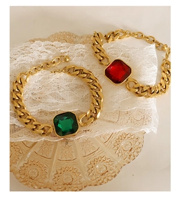 Detail of vintage chunky Cuban chain bracelets with emerald and ruby square crystals