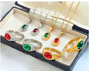 Retro jewelry collection with red and green crystal stones in a vintage blue box