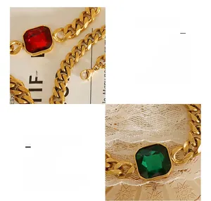 Macro view of gold-plated titanium cuban chain with red and green crystal stones
