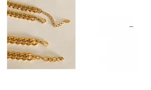 Close-up of golden Cuban link necklace with K18 engraved tag and lobster clasp
