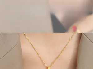 Close-up of gold-plated minimalist O-chain necklace worn by a model in casual business attire