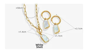 Detail view of gold necklace and earring set featuring rectangular white shell pendants