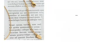 Close-up of golden titanium steel necklace with lobster clasp and K18 hallmark tag