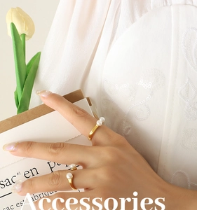 Detailed view of U-shaped open gold rings with white natural freshwater pearls for women
