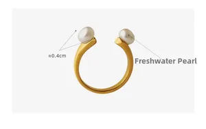 Detailed macro of a U-shaped gold ring featuring two 0.4cm natural freshwater pearls