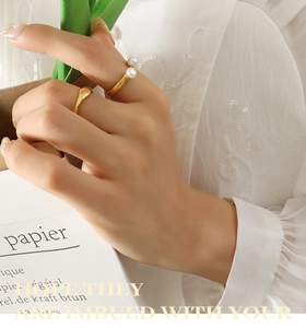 Detail of minimalist 18K gold plated U-shaped open ring with natural freshwater pearls