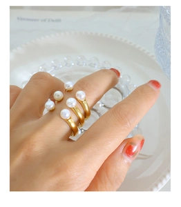 Baroque natural pearl ring set in matte gold finish featuring U-shaped open design details