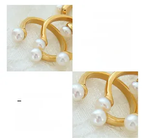 Close-up of baroque freshwater pearls on 18K gold-plated U-shaped adjustable ring