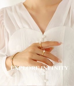 Close-up of Baroque freshwater pearl U-shaped open ring and colorful zircon bracelet