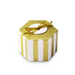 Close-up of a hexagonal gold striped gift box with gold metallic twine and tag