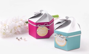 Macro shot of hexagon wedding favor gift boxes with ribbon and thank you stickers