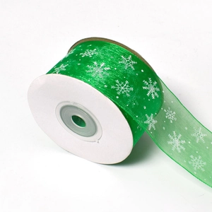 Green semi-transparent Christmas ribbon with white snowflake patterns on a 23-meter roll