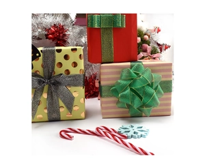 Detailed view of three festive Christmas gift boxes with glittery ribbons and bows