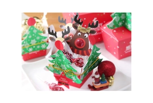 Close-up of cute reindeer lollipop cards and Christmas tree candy gift packaging