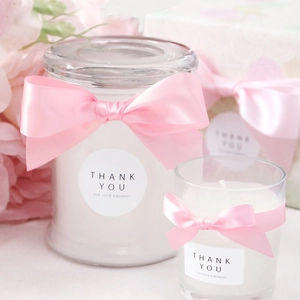 Elegant scented candle gift set with premium pink satin ribbons and floral decor