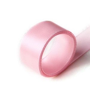 Roll of pink satin ribbon for gift wrapping with smooth texture and glossy silk finish