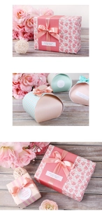 Detailed view of pink floral gift boxes with silk ribbon bows and thank you labels