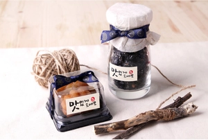 Close-up of traditional gift packaging with navy patterned ribbons and Korean tags