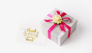 Detail of elegant gift box with rose pink satin ribbon and decorative white flower