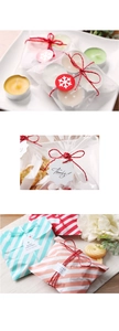 Macro shot of red raffia paper rope with decorative gift tags and polka dot packaging bags