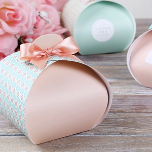 Elegant apricot pink and mint green wedding candy gift boxes with satin ribbon bows