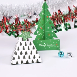 Detail view of pyramid Christmas gift box with tree pattern and green star tag
