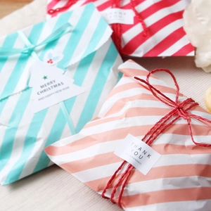 Three-color striped paper gift bags with Merry Christmas tags and thank you stickers