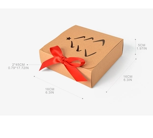 Detail view of square kraft gift box with Christmas tree cutout and red ribbon