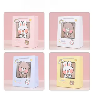 Detailed set of cute rabbit gift bags in four colors with clear window and rope handles