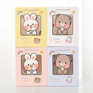 Detail of colorful gift bags with cute animal illustrations and clear square windows