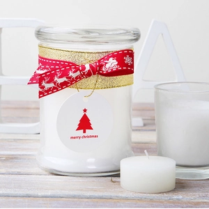 White Christmas candle jar with festive reindeer ribbon and a Merry Christmas tag