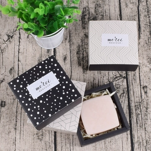 Polka dot and geometric square drawer gift box set with merci labels on wood desk