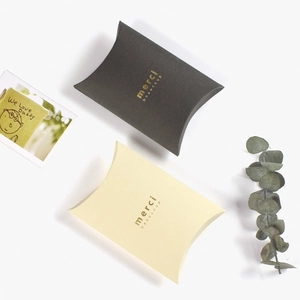 Minimalist black and beige pillow gift boxes with gold foil merci beaucoup lettering