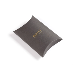 Minimalist dark grey pillow gift box with gold foil Merci Beaucoup text on white background