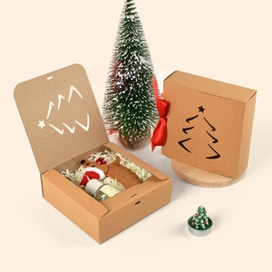 Square kraft paper Christmas gift boxes with laser-cut trees and red silk ribbons
