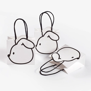 Minimalist white paper gift bag with cute black rabbit print and braided rope handles