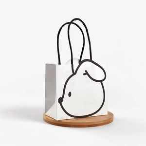 Minimalist white paper gift bag with cute black cartoon bunny design and rope handles