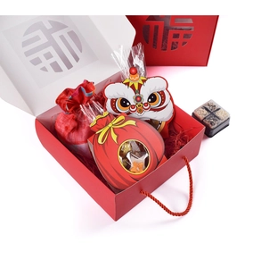 Detail of red festive Chinese gift box with Fu character cutout and lion dance packaging