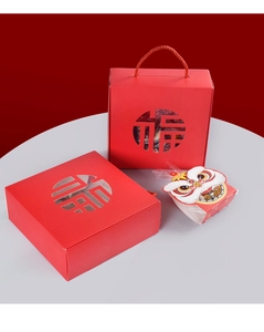 Detail of red festive gift box with Fu character cutout and lion dance pattern