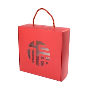 Red Chinese New Year gift box featuring Fu character hollow window and woven handles