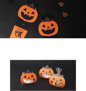 Detail of Halloween ghost pumpkin gift boxes with cutout smiles for cookies and candy
