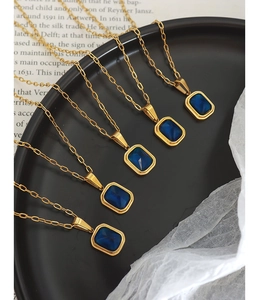 Détail de cinq colliers plaqués or 18 carats avec pendentifs rectangulaires en cristal bleu