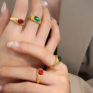 Vintage PVD gold plated rings with red and green crystals on textured metal bands