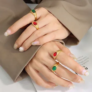 Vintage Egyptian style gold plated ring set with red and green gemstones and zircons